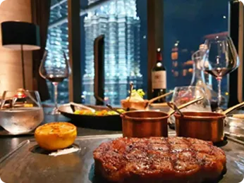A fancy dinner at an upscale restaurant, enjoyed for free by a Play88 VIP club member.
